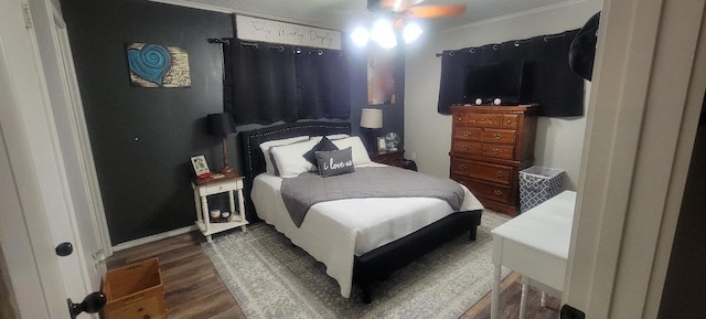 bedroom featuring crown molding, ceiling fan, and dark hardwood / wood-style flooring