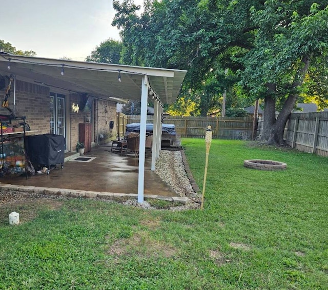 view of yard featuring a patio and an outdoor fire pit