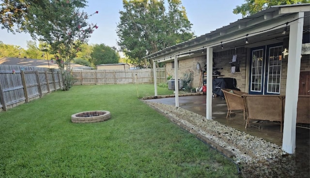 view of yard featuring a patio and central AC