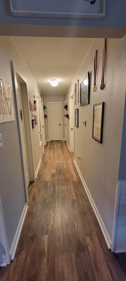 corridor with wood-type flooring