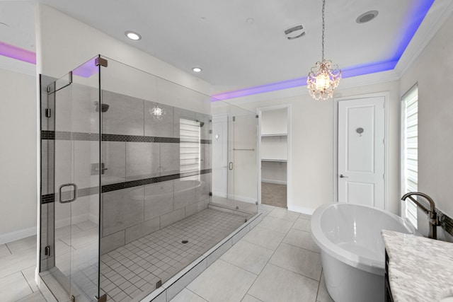 bathroom with tile floors, a notable chandelier, ornamental molding, and plus walk in shower