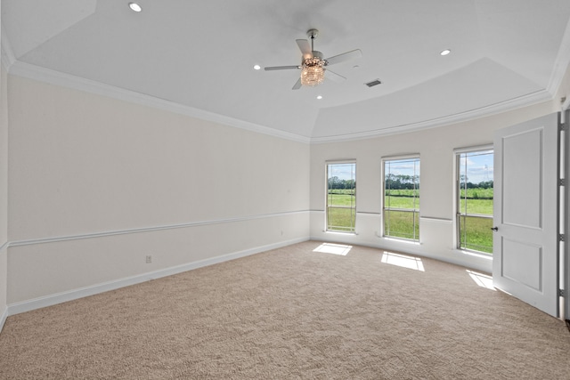 empty room with crown molding, a wealth of natural light, carpet flooring, and ceiling fan