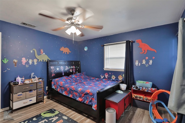 bedroom with ceiling fan and hardwood / wood-style flooring