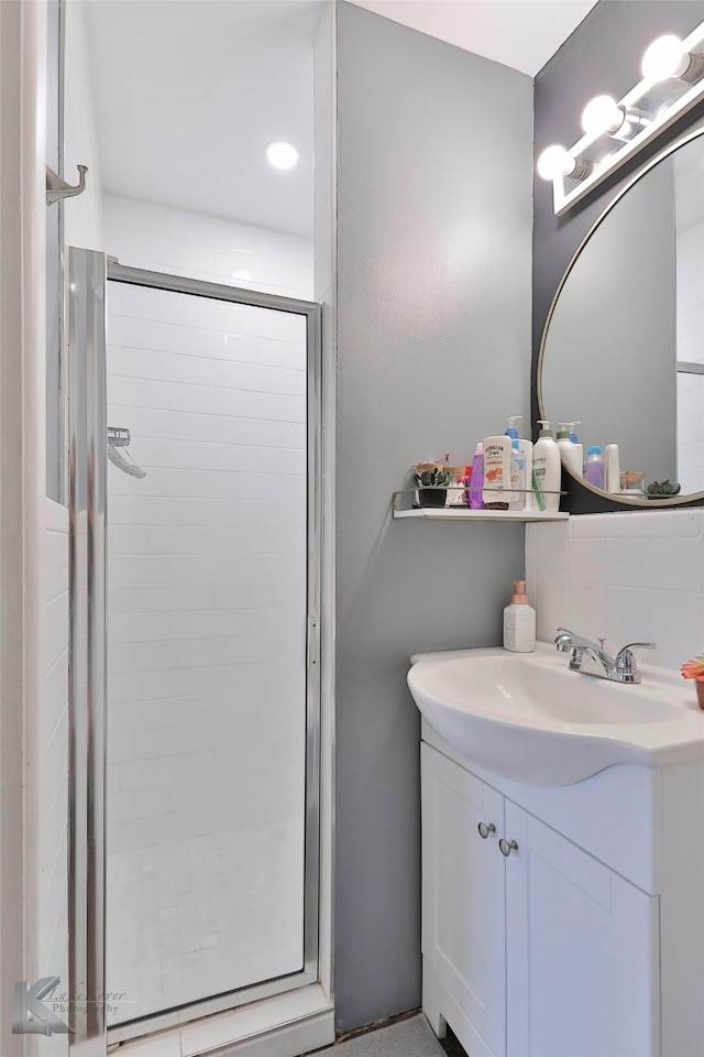 bathroom with vanity and a shower with shower door