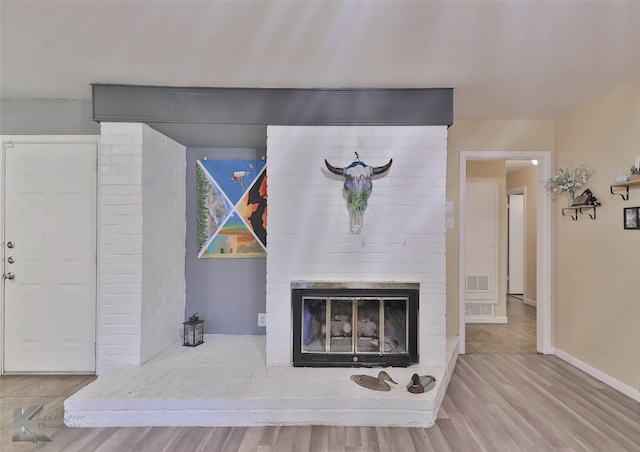 interior details with a fireplace and wood-type flooring