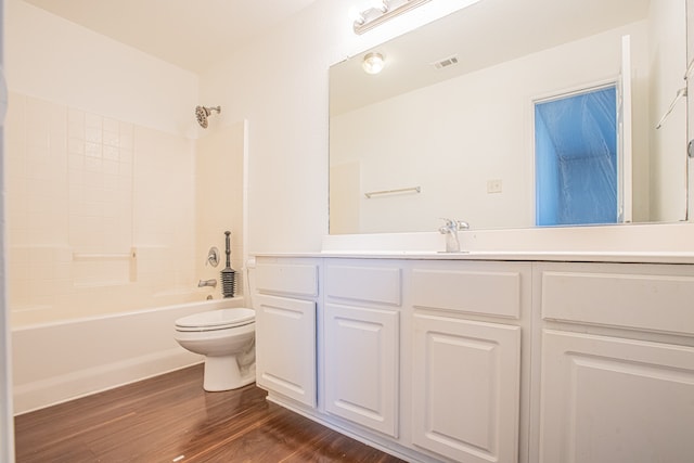 full bathroom featuring toilet, shower / bathing tub combination, hardwood / wood-style floors, and vanity