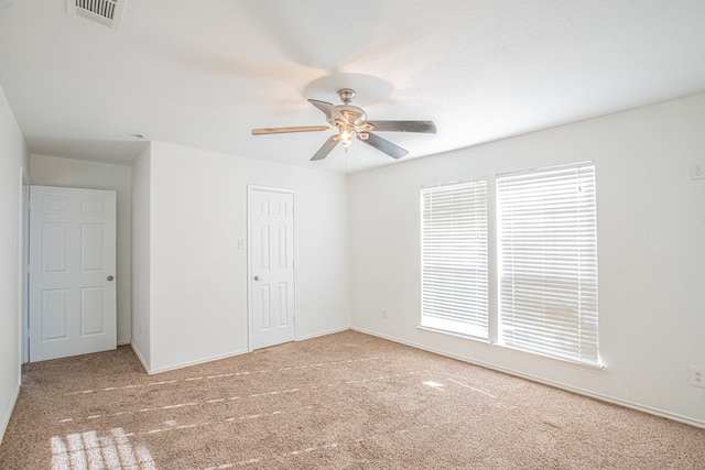 carpeted empty room with ceiling fan