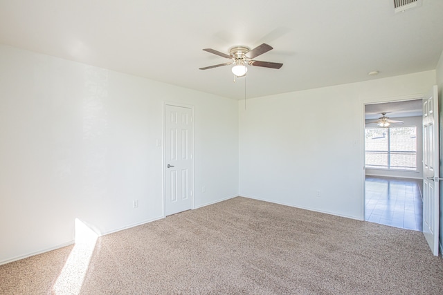 empty room with carpet floors and ceiling fan