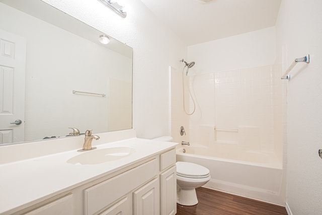 full bathroom featuring toilet, bathtub / shower combination, hardwood / wood-style floors, and vanity