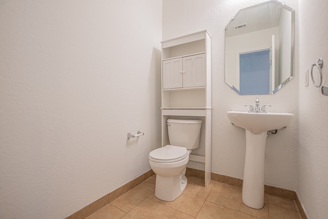 bathroom featuring toilet and tile patterned floors