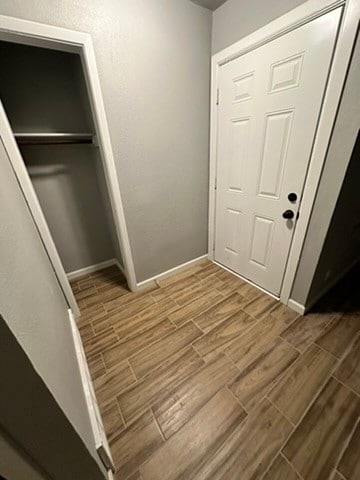 interior space with wood-type flooring and a closet