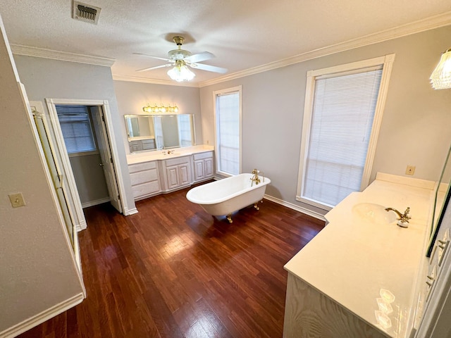 unfurnished bedroom with ceiling fan, crown molding, dark hardwood / wood-style floors, a textured ceiling, and sink