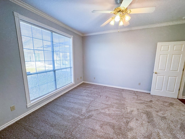 carpeted empty room with ornamental molding, ceiling fan, and a wealth of natural light