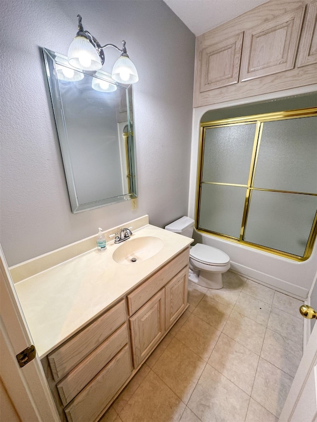 full bathroom with toilet, tile flooring, vanity, and shower / bath combination with glass door