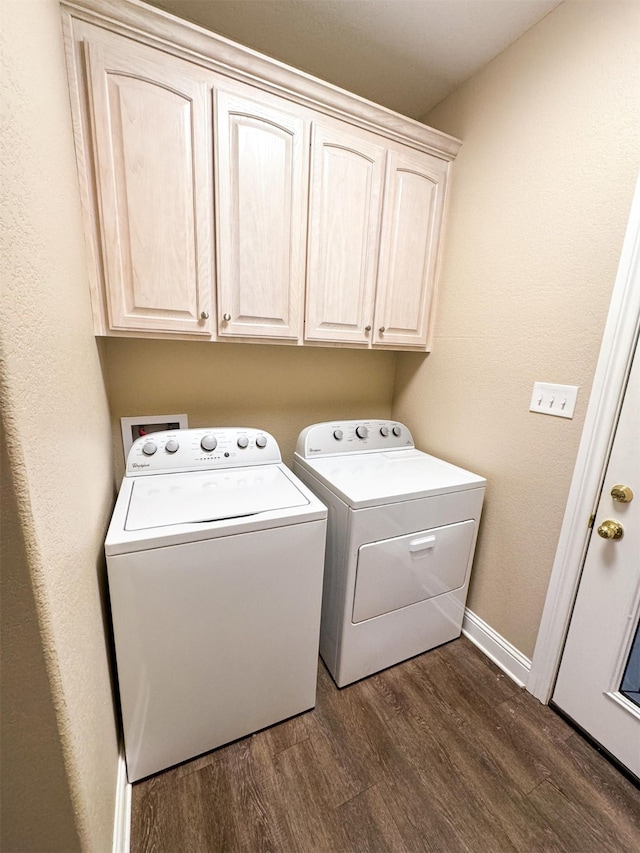 clothes washing area with cabinets, washer hookup, washing machine and clothes dryer, and dark wood-type flooring