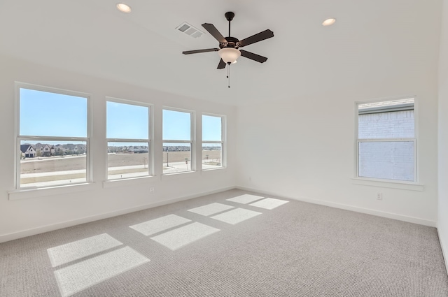 spare room featuring ceiling fan and carpet