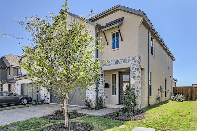 view of front of home with a front lawn and a garage