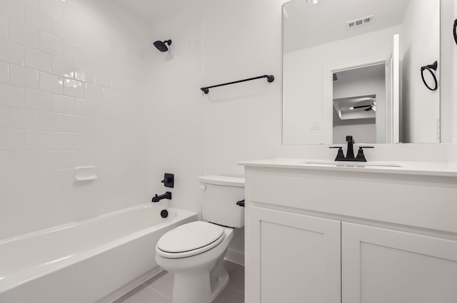 full bathroom featuring tiled shower / bath, vanity, toilet, and tile patterned floors