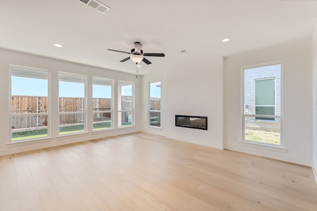 unfurnished living room with light hardwood / wood-style floors and ceiling fan