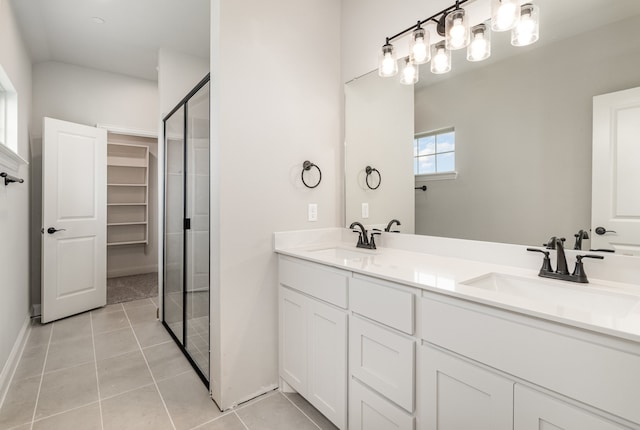 bathroom featuring an enclosed shower, dual bowl vanity, and tile floors