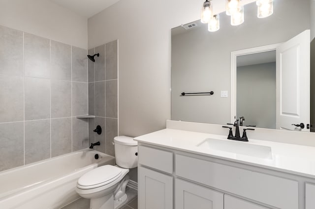 full bathroom with vanity with extensive cabinet space, toilet, tile flooring, and tiled shower / bath combo