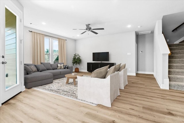 living room with ceiling fan and light hardwood / wood-style floors