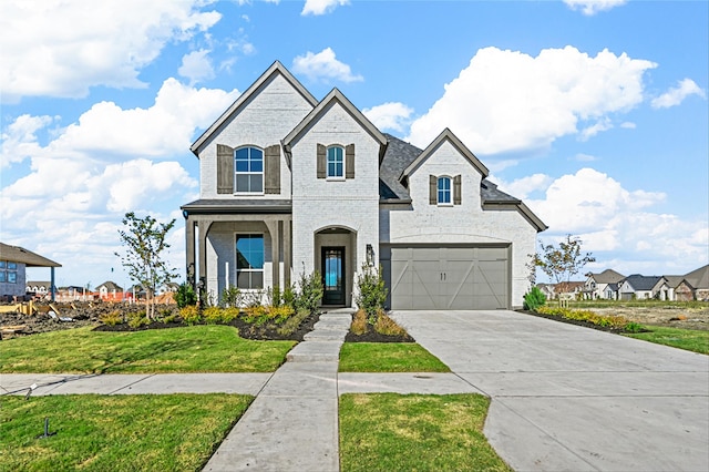 view of front of home featuring a garage and a front lawn