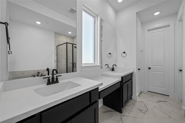 bathroom with vanity and a shower with shower door