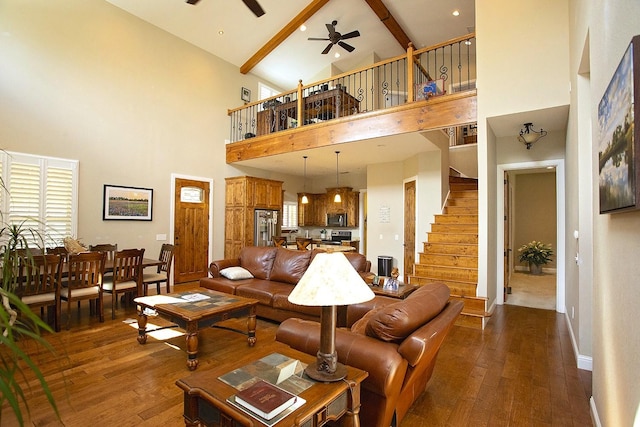 living room with dark wood-type flooring, ceiling fan, and a healthy amount of sunlight