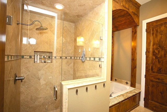 bathroom featuring separate shower and tub