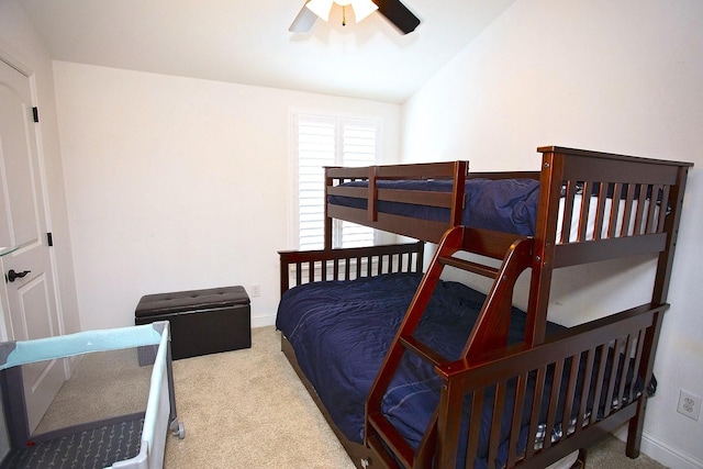 bedroom featuring ceiling fan, light colored carpet, and vaulted ceiling