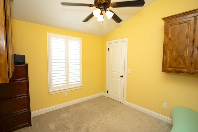 unfurnished bedroom with lofted ceiling, light colored carpet, and ceiling fan