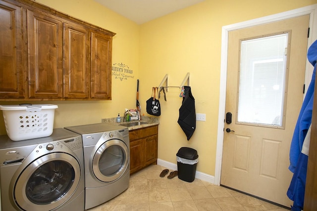 laundry area featuring cabinets, sink, and independent washer and dryer