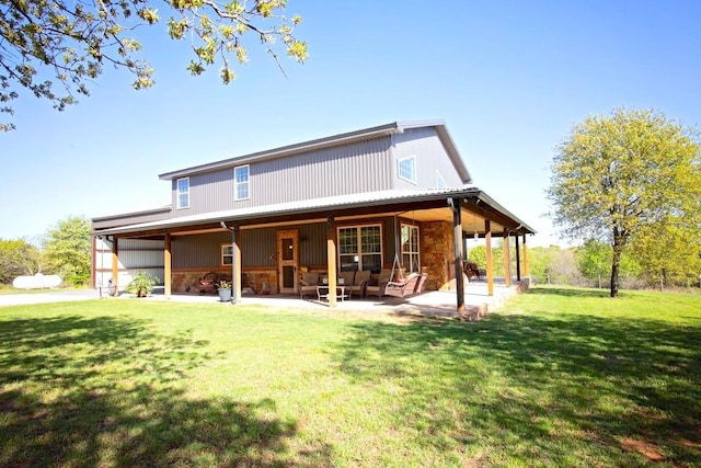 back of property with a patio and a lawn