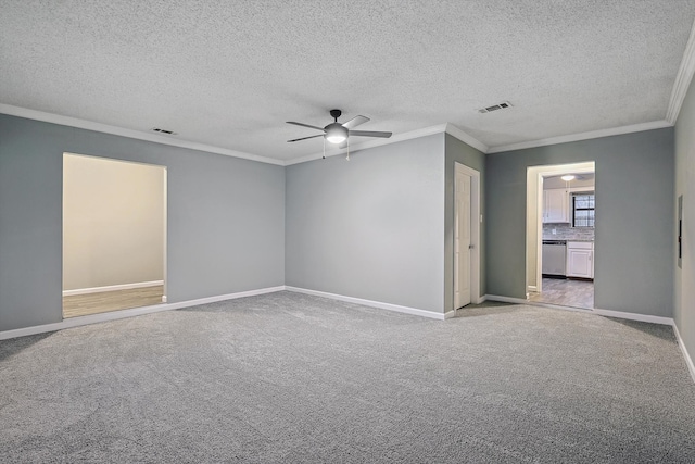 carpeted empty room with ornamental molding, ceiling fan, and a textured ceiling