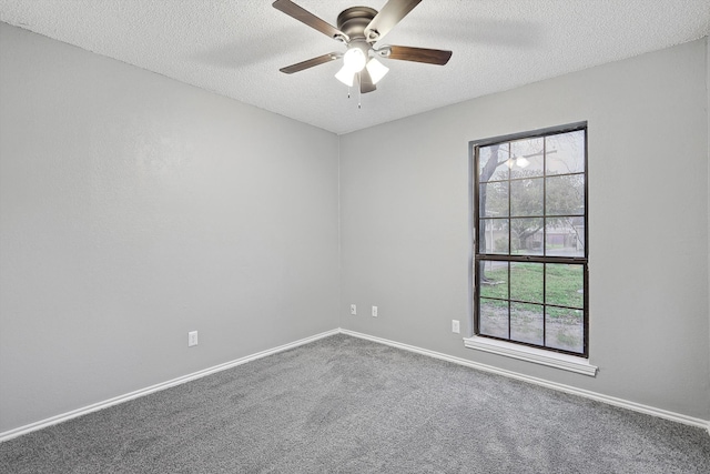 carpeted spare room with ceiling fan and a textured ceiling