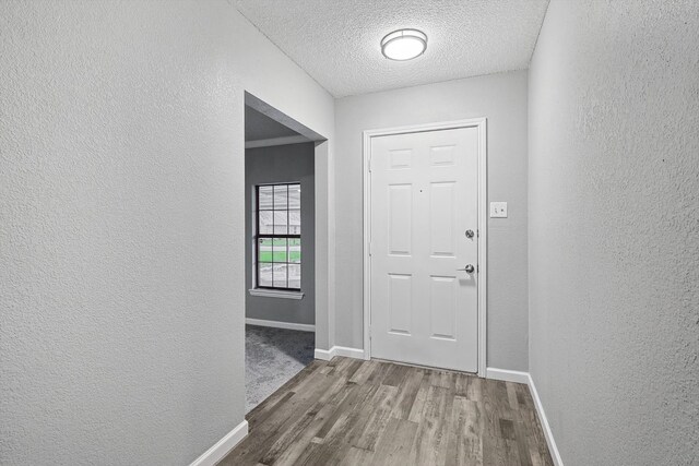 entryway with a textured ceiling and hardwood / wood-style floors