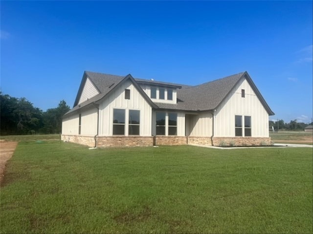 rear view of property with a yard