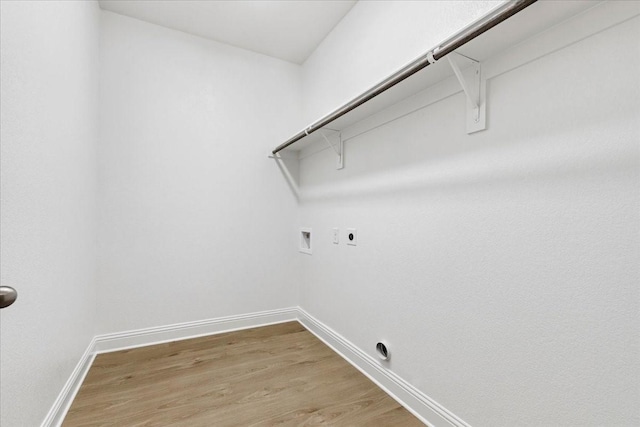 clothes washing area with hookup for an electric dryer, hardwood / wood-style flooring, and washer hookup