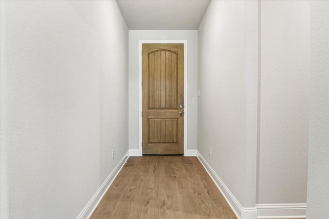 hallway with light hardwood / wood-style flooring