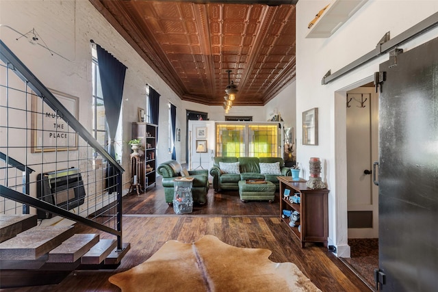 interior space with an ornate ceiling, crown molding, stairway, and dark wood-type flooring