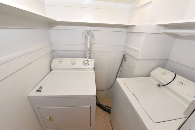 laundry area featuring light tile floors and separate washer and dryer