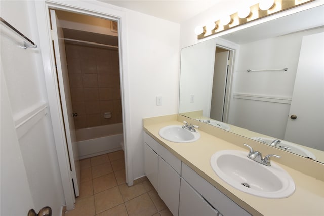 bathroom with double sink, tiled shower / bath combo, tile floors, and oversized vanity