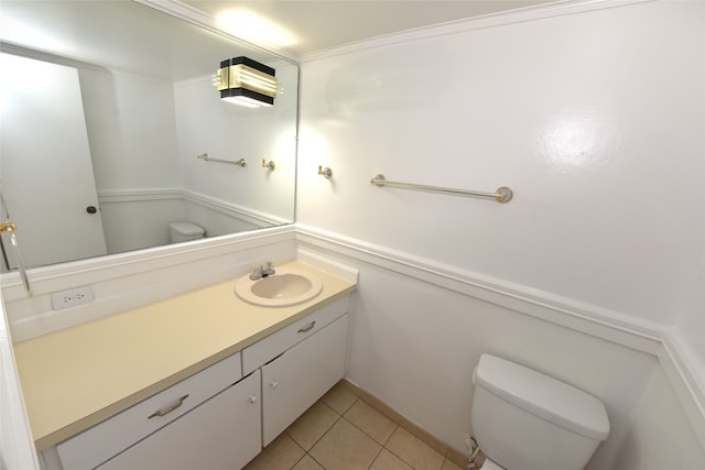 bathroom featuring tile flooring, ornamental molding, vanity, and toilet