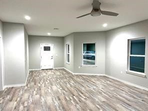 foyer featuring wood-type flooring and ceiling fan