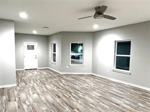 unfurnished room featuring ceiling fan and hardwood / wood-style floors