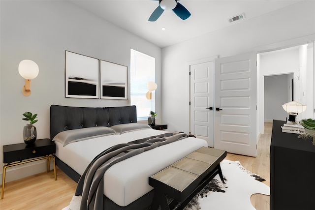 bedroom featuring ceiling fan, a closet, and light hardwood / wood-style floors