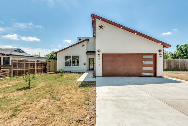 contemporary house with a front lawn and a garage