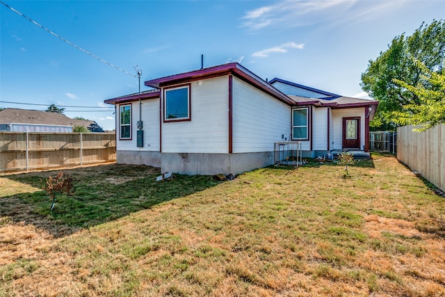 rear view of house with a yard