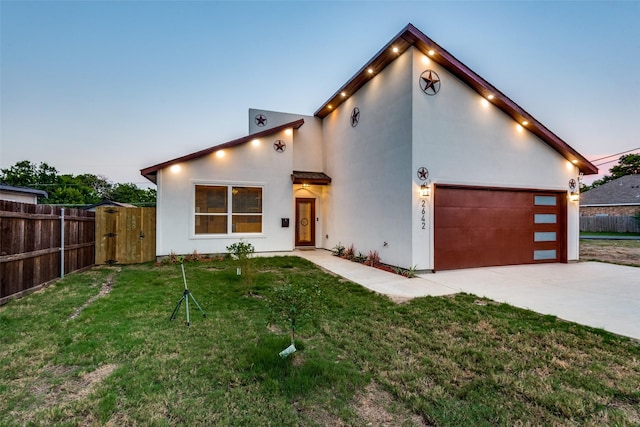 view of front facade featuring a lawn and a garage